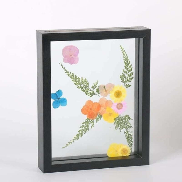 A modern rectangular photo frame displaying dried flowers, perfect for showcasing children's art projects.