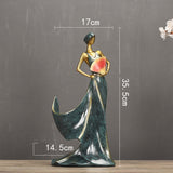Elegant resin figurine of a woman in a flowing dress, perfect for home decoration and artistic displays.