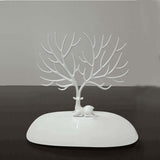 White deer and tree jewelry display stand on a smooth base, perfect for showcasing earrings and necklaces.