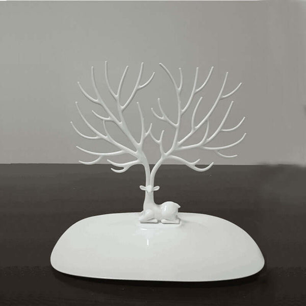 White deer and tree jewelry display stand on a smooth base, perfect for showcasing earrings and necklaces.