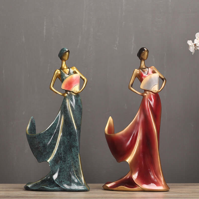 Elegant resin statuettes of women in flowing gowns holding fans, perfect for home decor and gifting.