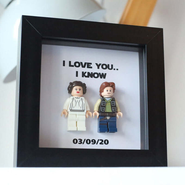 Personalized photo frame featuring LEGO figures with the text 'I LOVE YOU.. I KNOW' and a date, ideal for anniversaries.