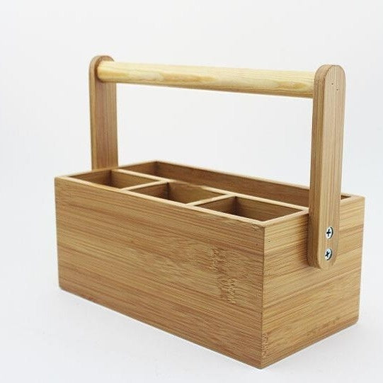 Bamboo drawer container for kitchen utensils, featuring a handle and multiple compartments for organization.