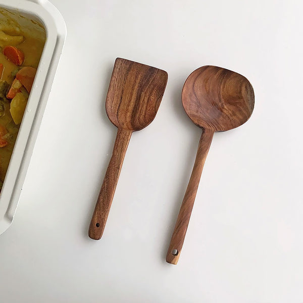 Wooden Korean kitchen utensils including a flat shovel and wide mouth spoon, perfect for modern cooking.