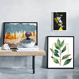 Modern decor featuring solid wood picture frames with nature and geometric art on a stylish table.
