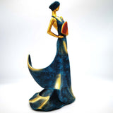 Handcrafted resin ornament of a graceful figure in blue and gold, decorative for home living room.