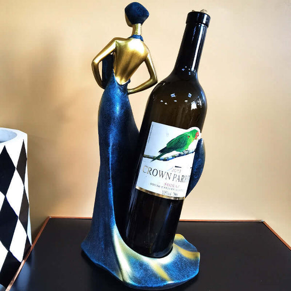 Blue and gold resin wine rack ornament with a stylish figure holding a wine bottle, perfect for home decor.