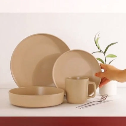 Set of luxury ceramic baking utensils in warm beige tones, including plates and a mug, ideal for stylish kitchen use.
