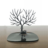 Stylish black metal tree-shaped jewelry display stand for earrings and necklaces.